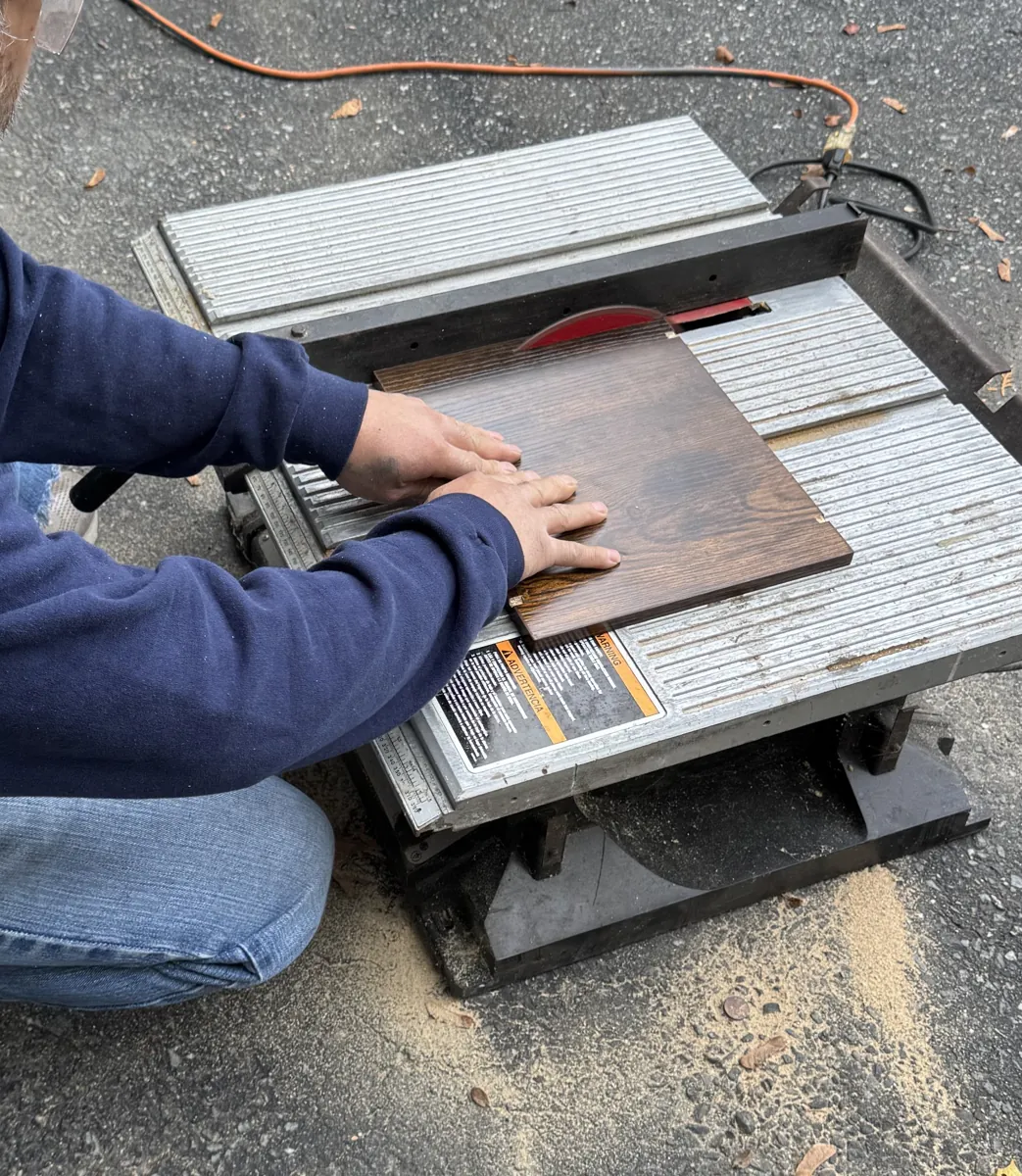 Cutting a wood panel on a table saw